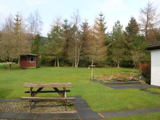 Back garden with fish pond and seating area